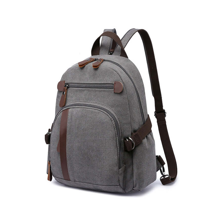 Convertible canvas sling bag worn as a backpack in grey color