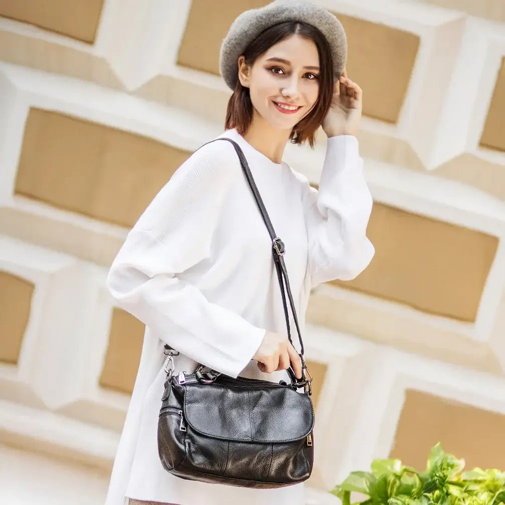 Stylish everyday look with black leather bag paired with a white dress.
