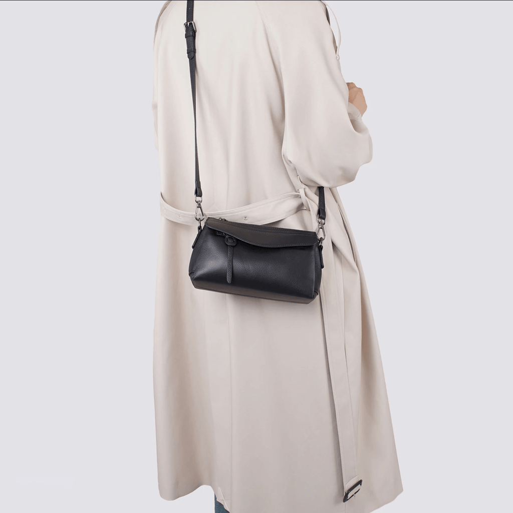 Women wearing black small leather bag in crossbody style