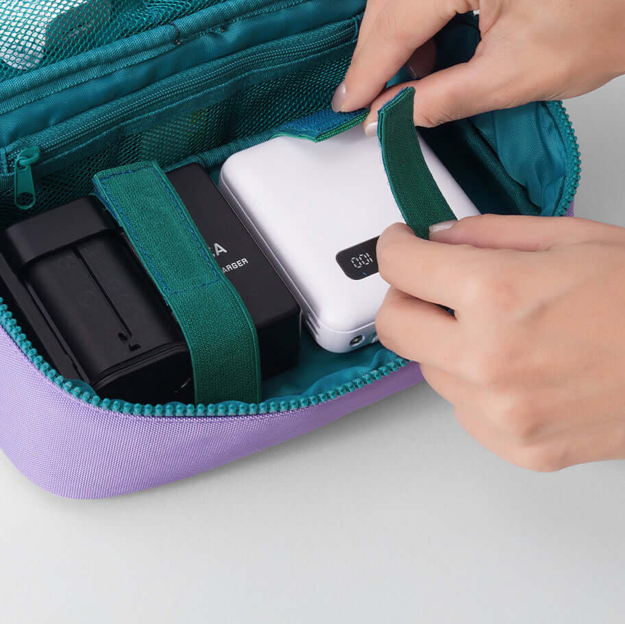 Velcro straps securing power banks and electronics.