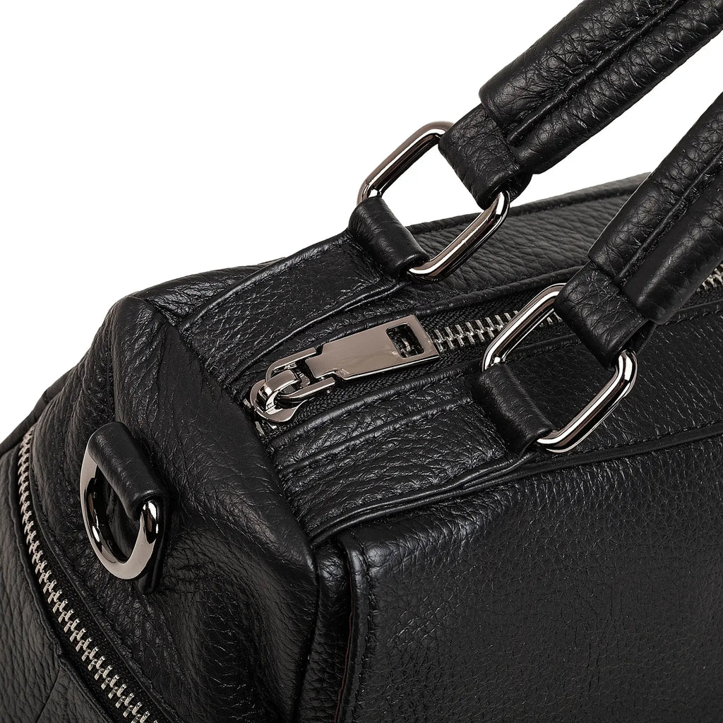 Close-up of soft grain texture on black leather handbag.