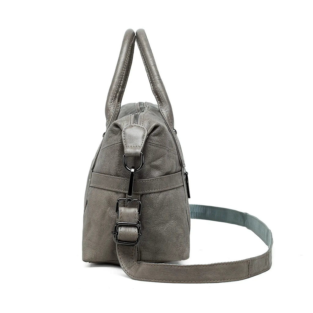 Side view of women’s grey leather handbag with structure detail