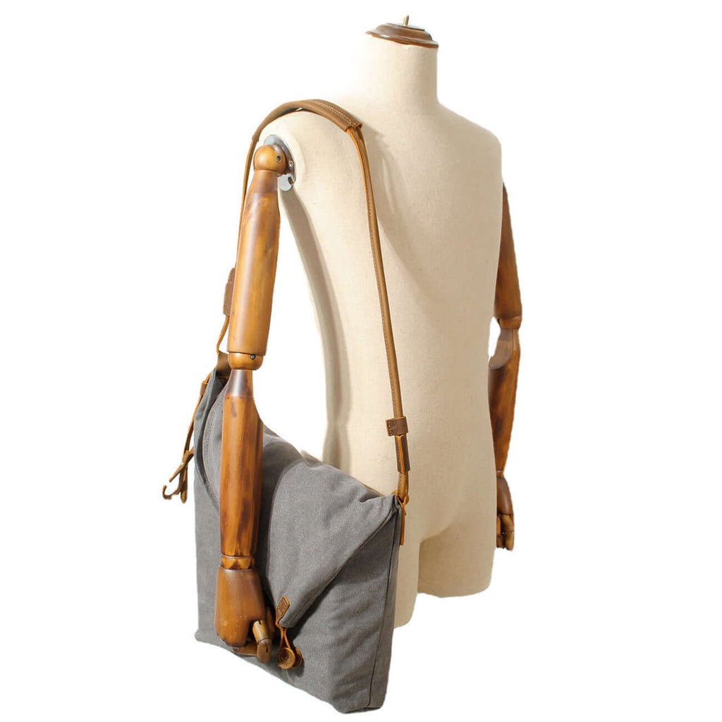Grey shoulder bag worn by woman casually