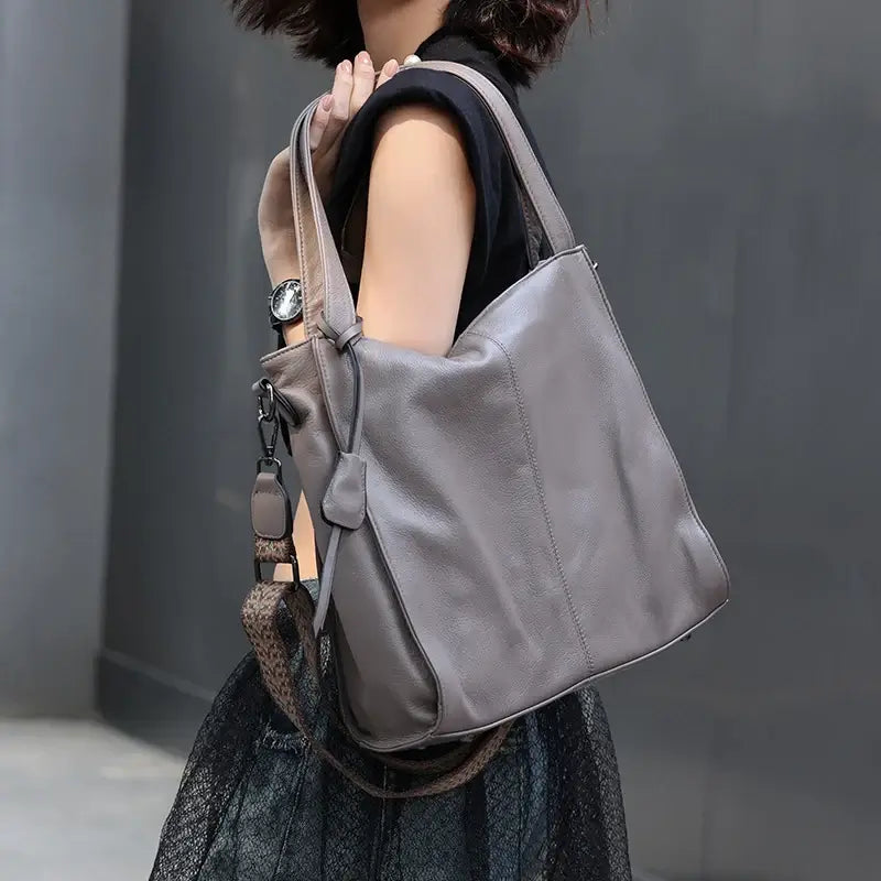 Grey tote worn over shoulder showing handle length