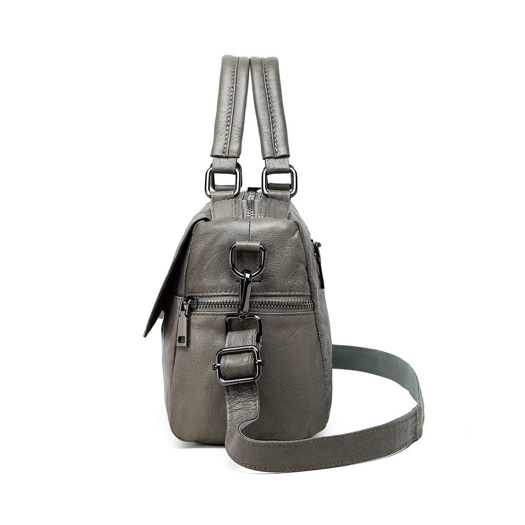 Grey handbag with functional side zipper pocket and elegant finish.