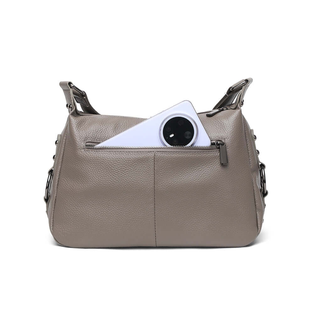 Showing the back zippered compartment of the grey leather crossbody bag