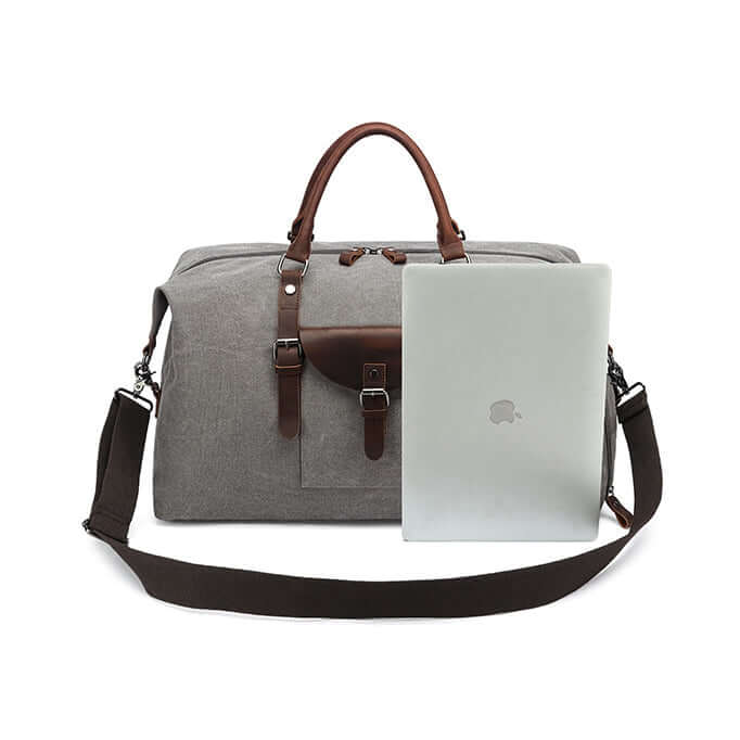 Grey travel bag with brown straps and a brown shoulder strap, containing an laptop