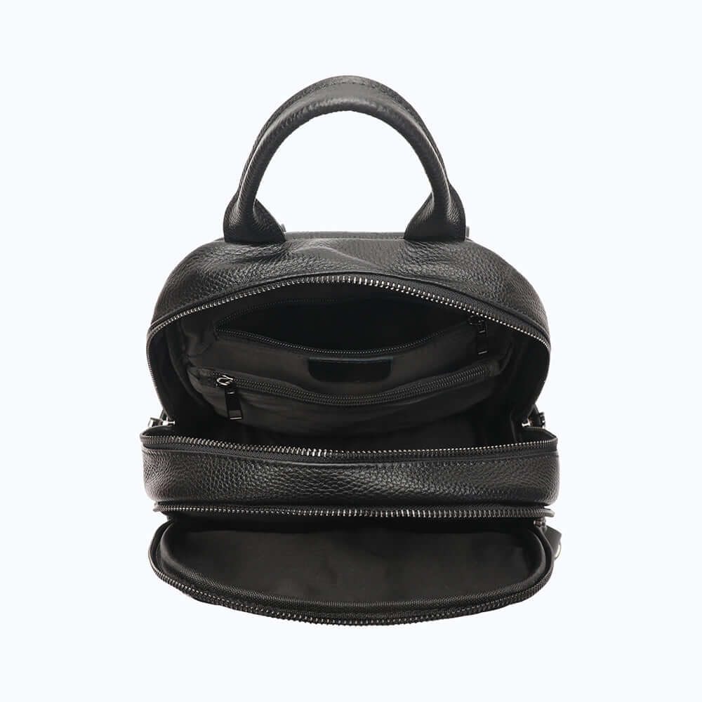 Open leather backpack showing inside capacity