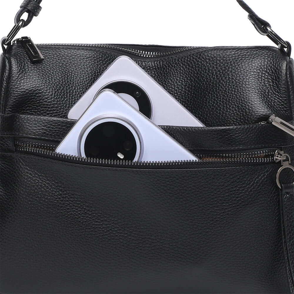 Front zipper pocket detail on leather shoulder bag