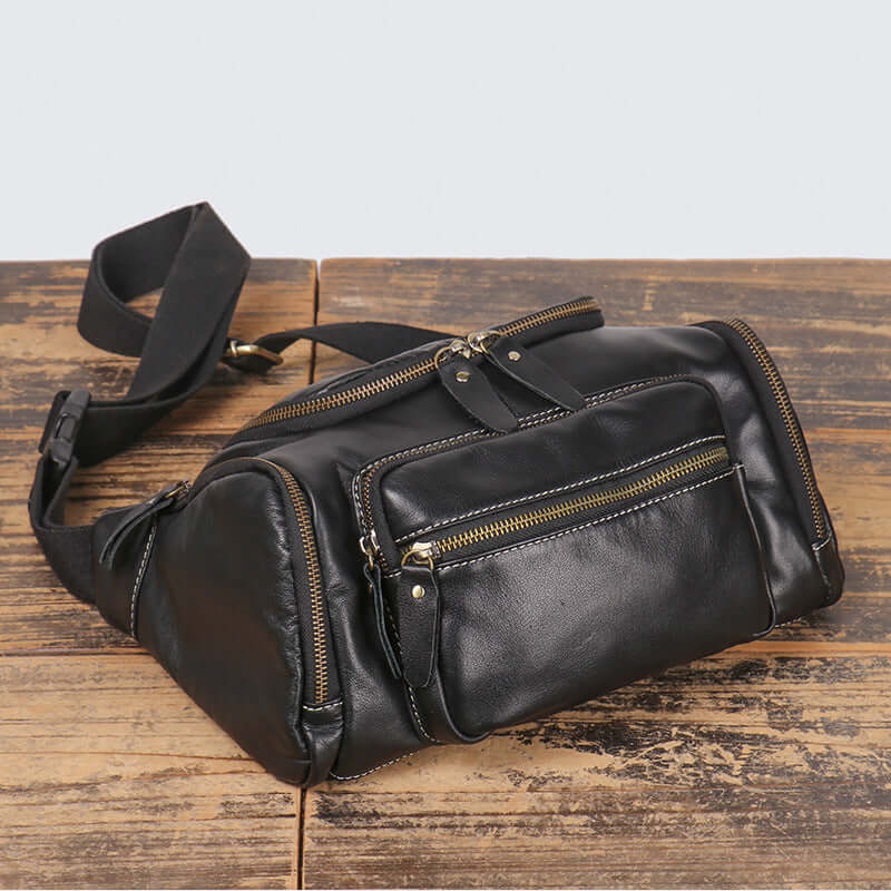 full display of men’s black leather crossbody waist bag