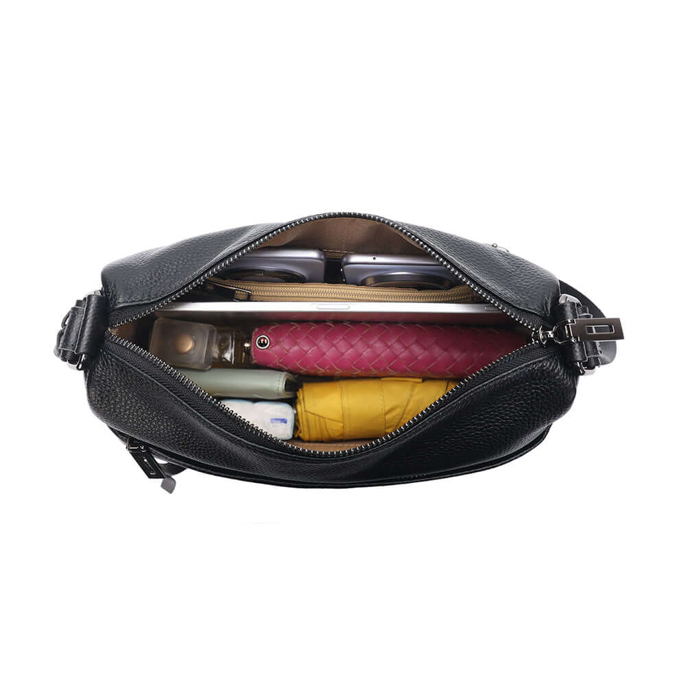 everyday items displayed beside leather bag