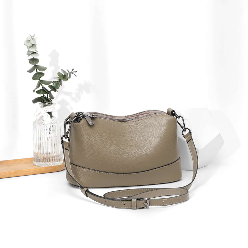 Taupe leather bag in lifestyle setting.