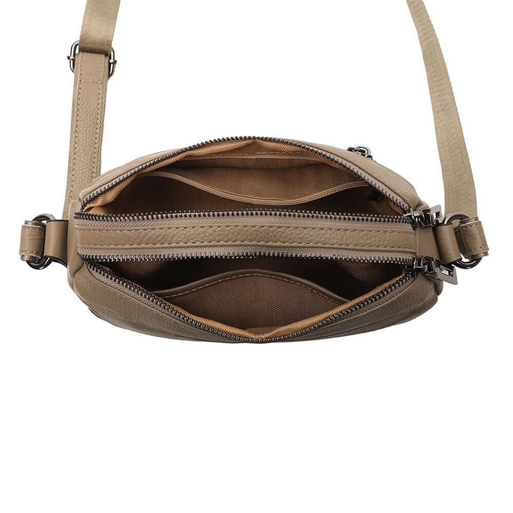 Open view of main compartments inside leather crossbody bag