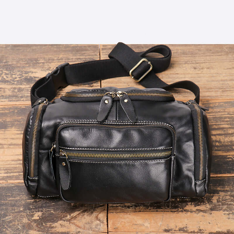 angled view of men’s leather crossbody waist bag in black
