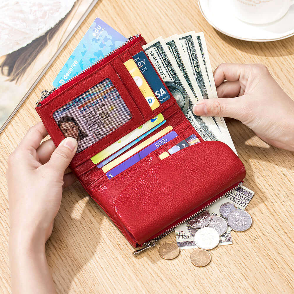 Red leather envelope wallet opened, showcasing organized compartments.