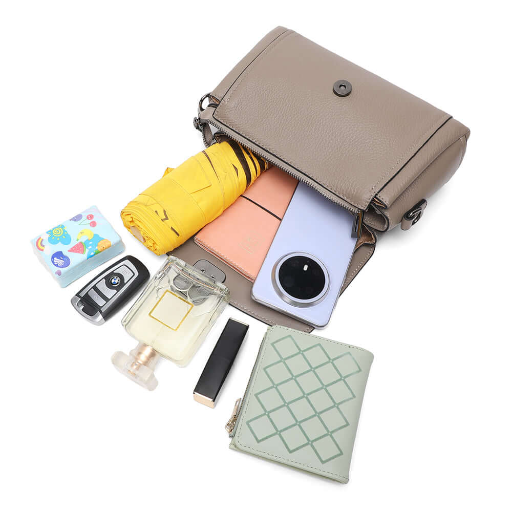 everyday essentials placed around leather flap shoulder bag