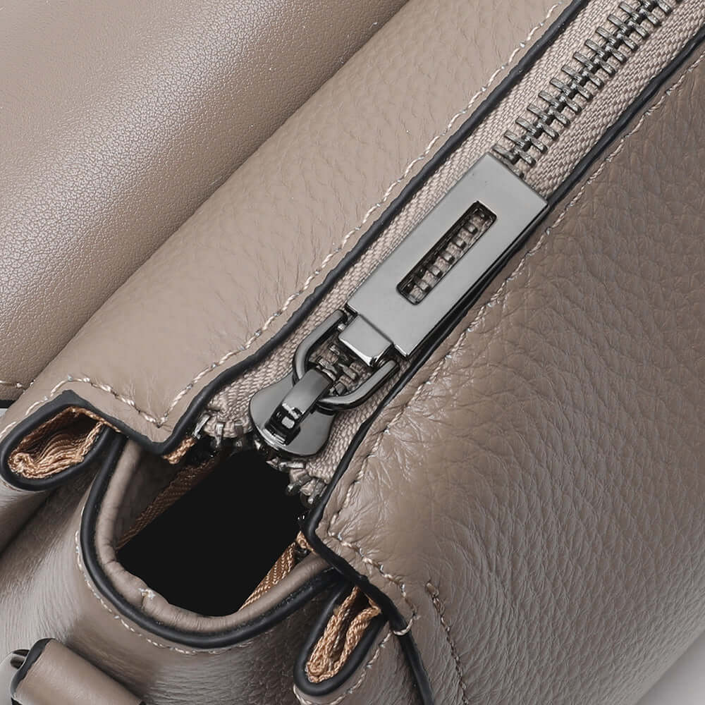Metal buckle and strap hardware details of leather bag