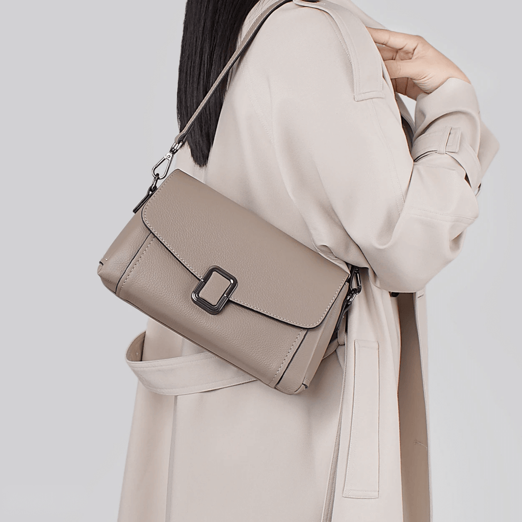 woman carrying leather flap shoulder bag in daily outfit