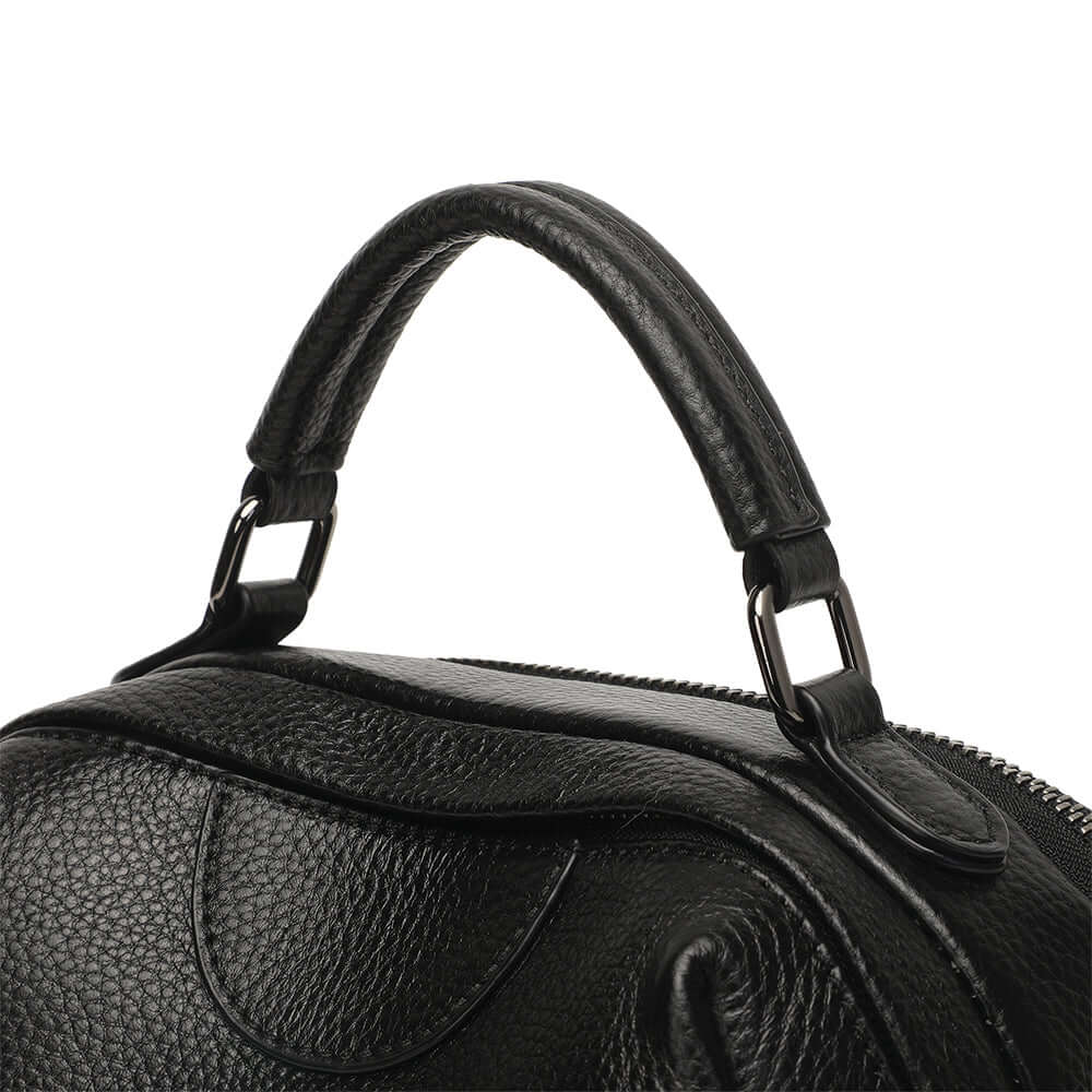 Black leather handbag metal hardware close-up