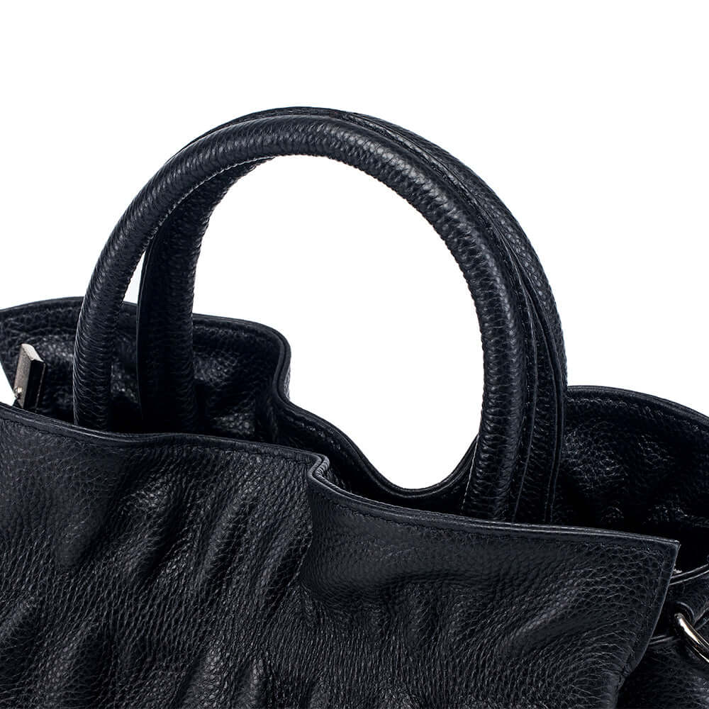 Close-up of pleated leather texture in black