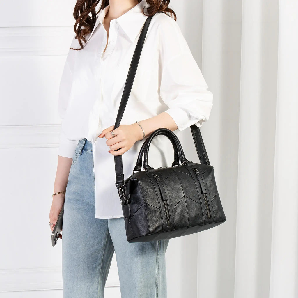 Model wearing black leather handbag as crossbody bag
