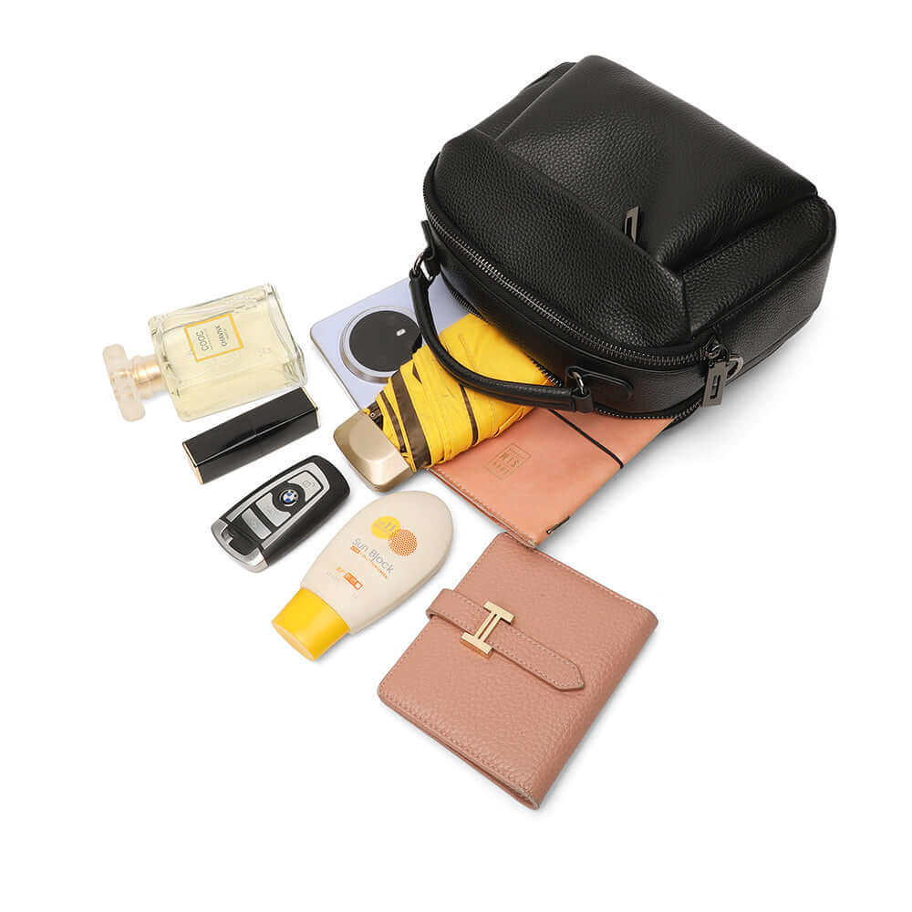 Everyday items displayed beside handbag