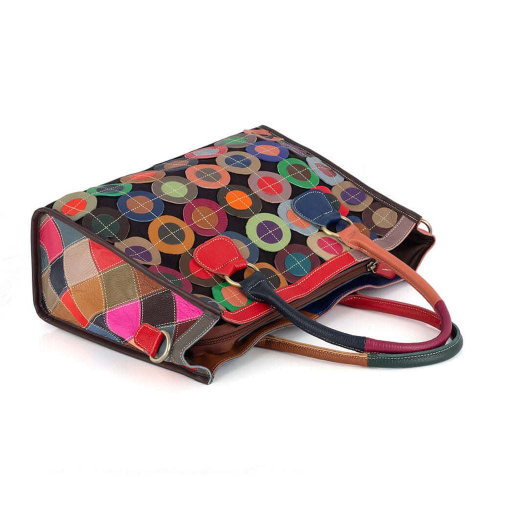 Colorful leather handbag carried by hand