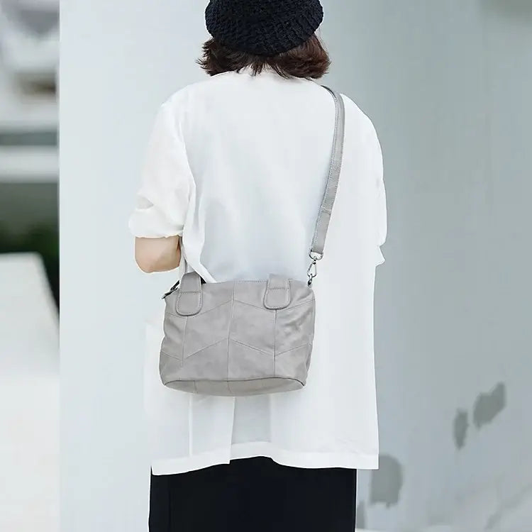 Leather handbag shown crossbody on model
