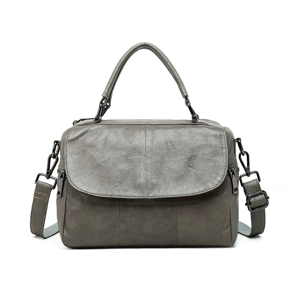 Front view of grey leather handbag with structured shape and smooth flap.