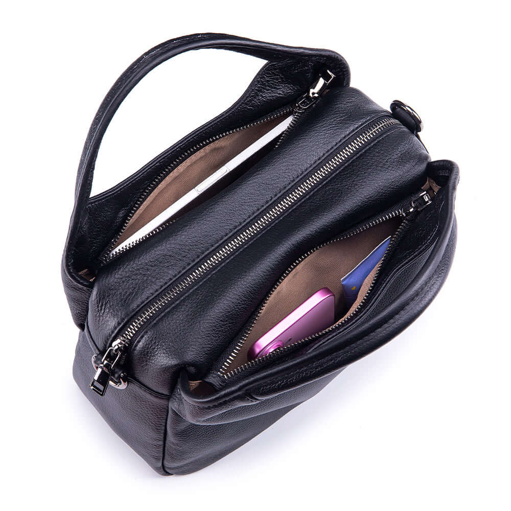 top opening of leather shoulder bag with items