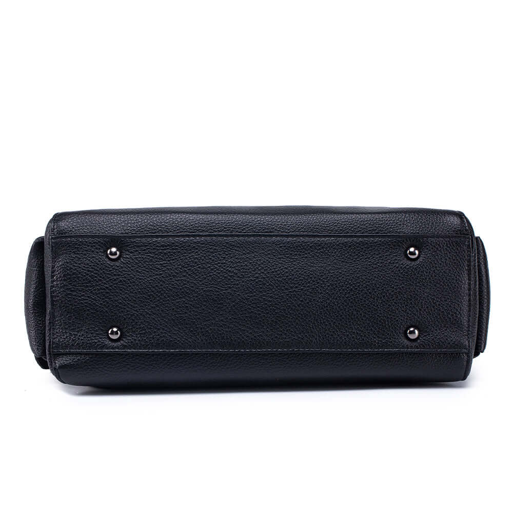 Bottom studs and leather texture detail of handbag.