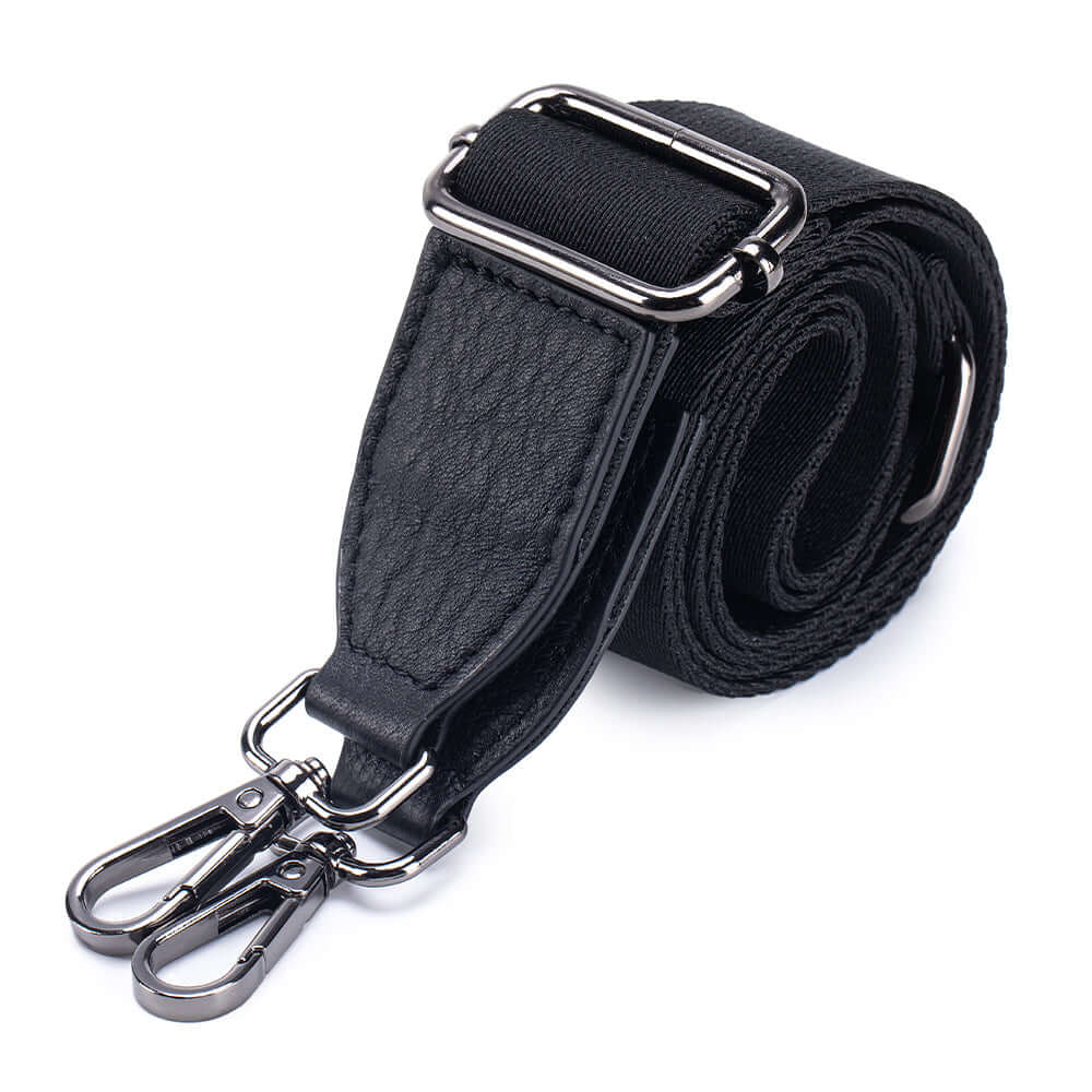 Short leather hand strap detail on multi-strap handbag.