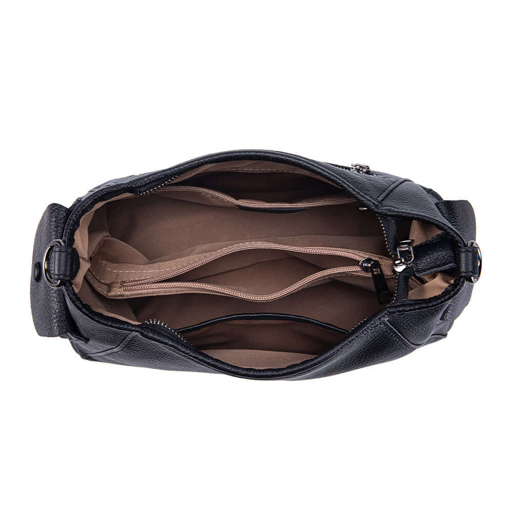 Interior compartments and zipper pockets of leather shoulder bag.