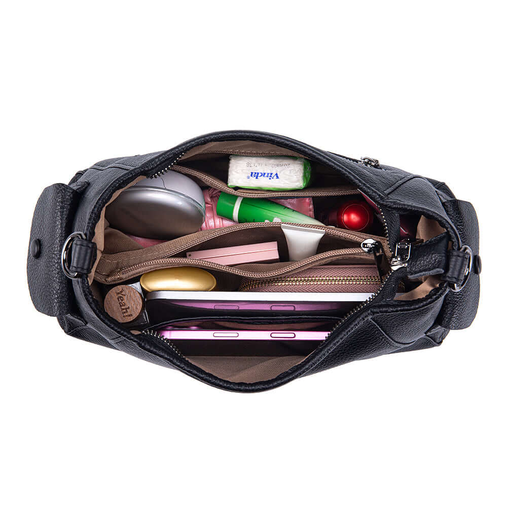 Leather bag filled with iPad, cosmetics and essentials.