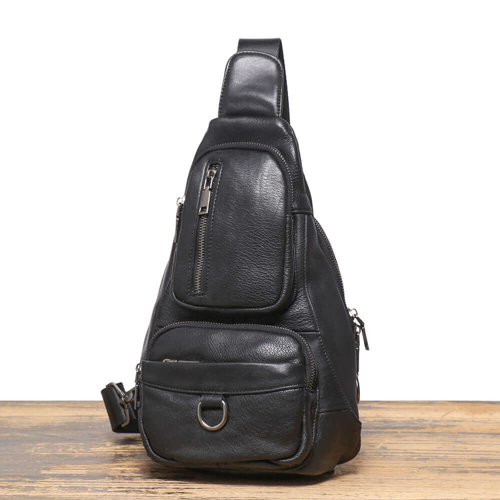 angled view of men’s black leather sling crossbody bag