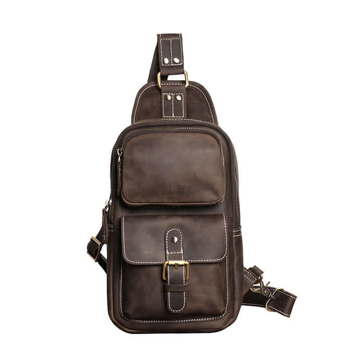 Leather sling bag in vintage brown leather – front view showing dual pockets and buckle strap.