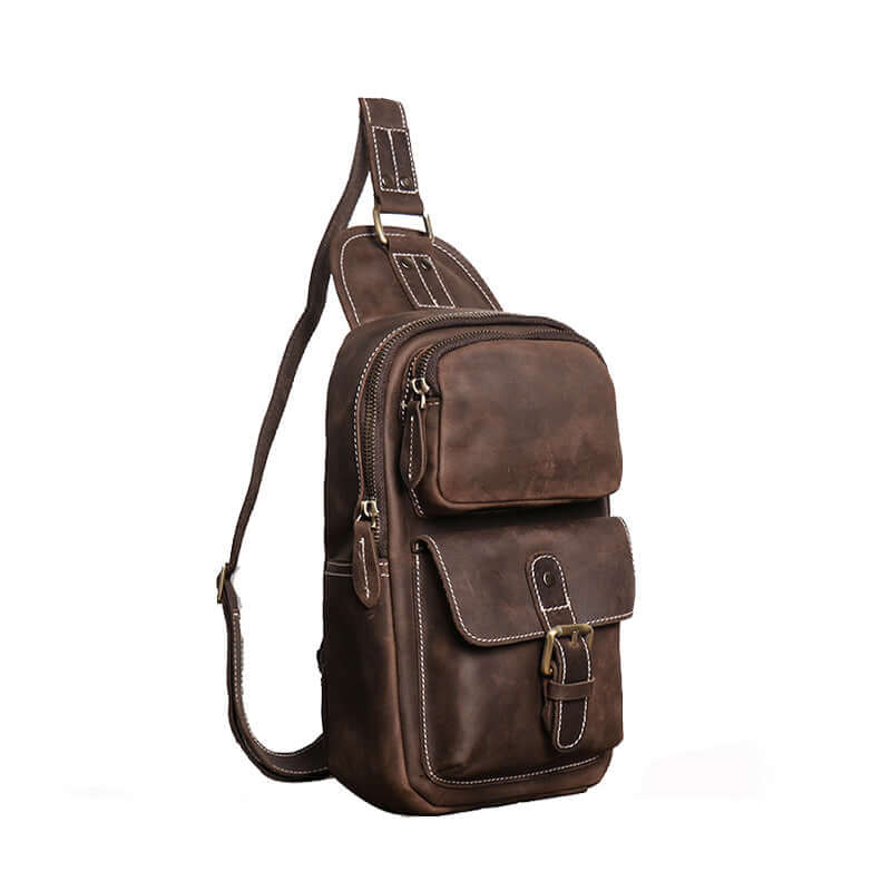 Side angle of vintage leather crossbody chest pack with multi-pocket design and fine stitching.