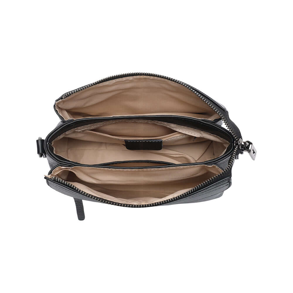 Interior lining and compartments of black leather mini crossbody bag.