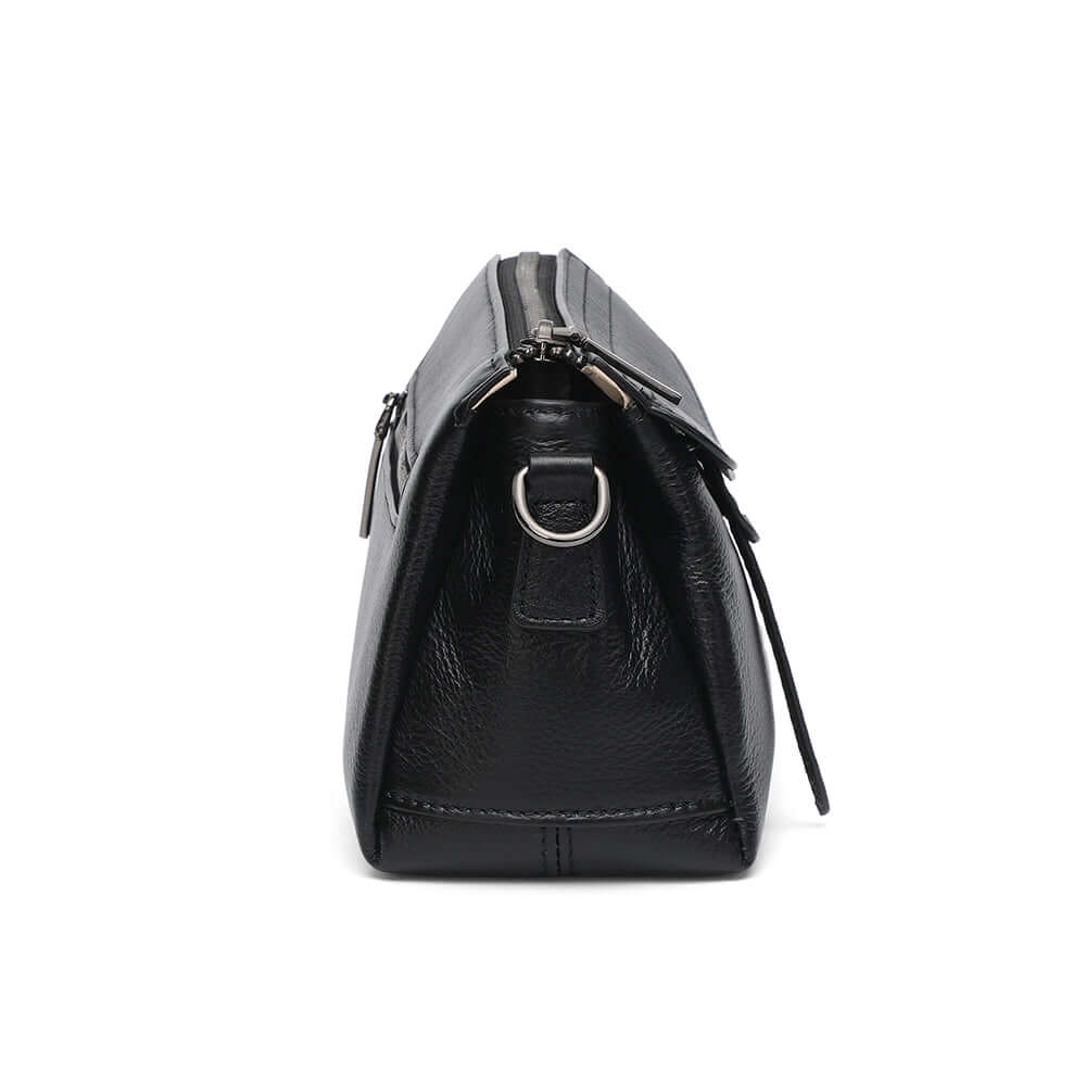 Side angle view of black leather small shoulder crossbody purse.