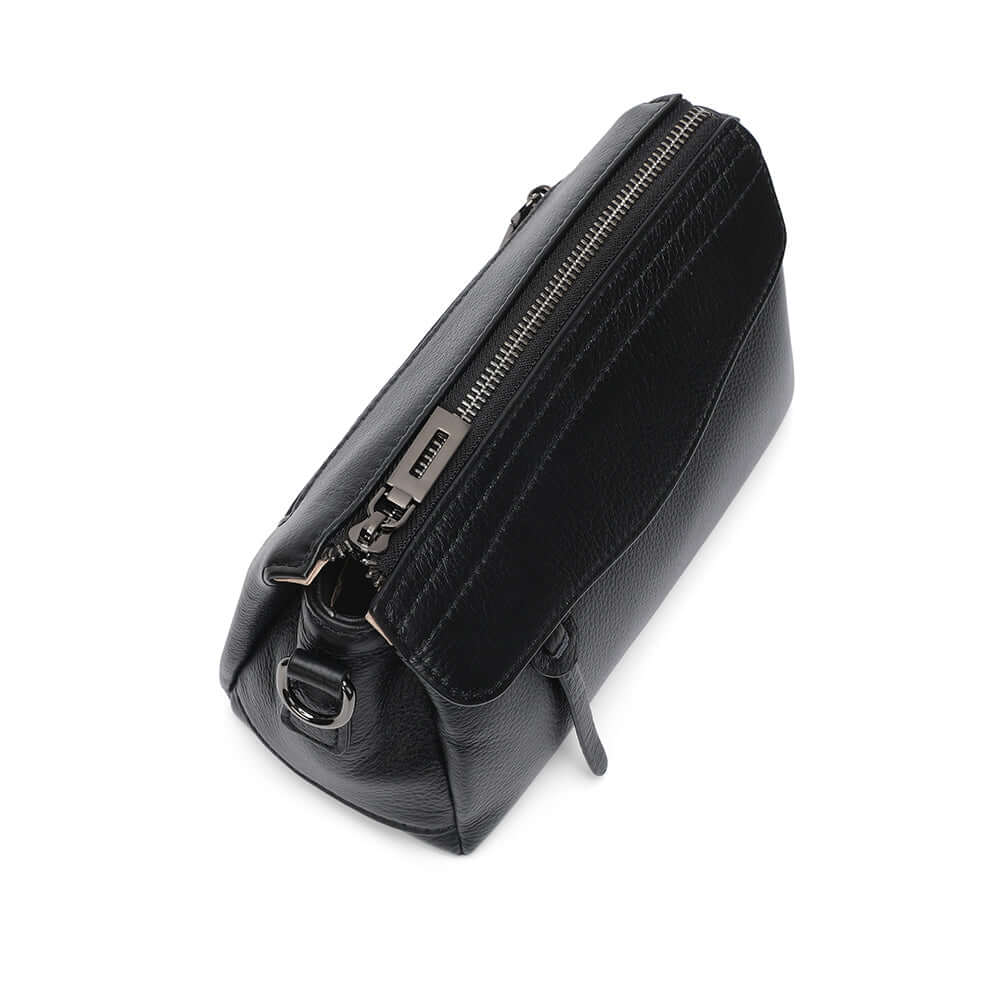 Top zipper design of compact women’s black leather crossbody bag.