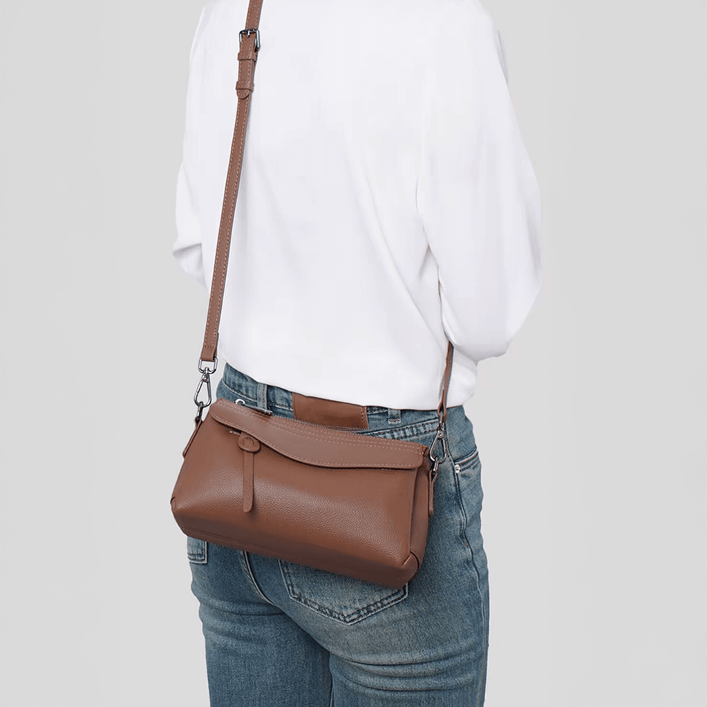 Women wearing coffee small leather bag in crossbody style.