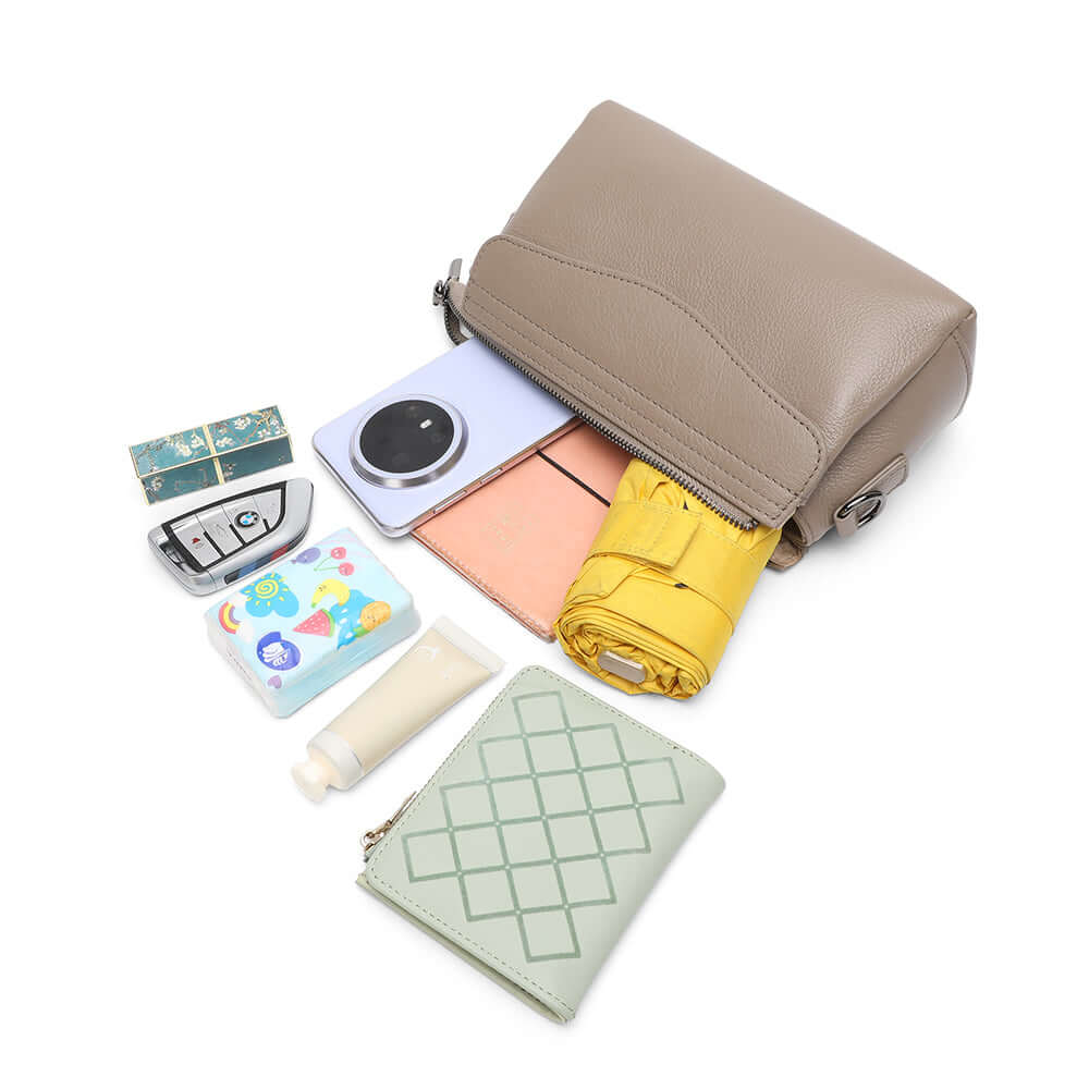 Inner capacity display of women’s small taupe leather shoulder bag