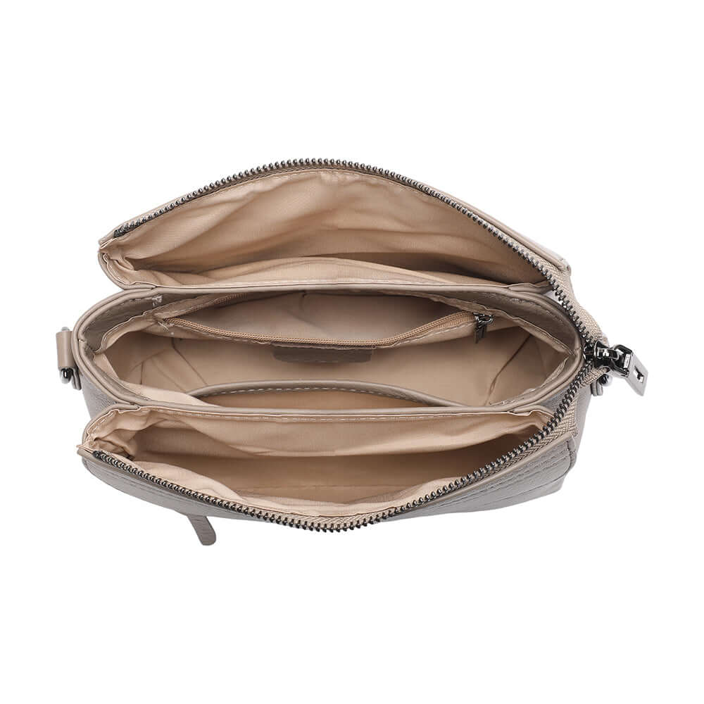Interior lining and compartments of taupe leather mini crossbody bag.