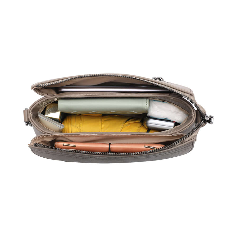 Open top view of women’s compact taupe leather crossbody purse