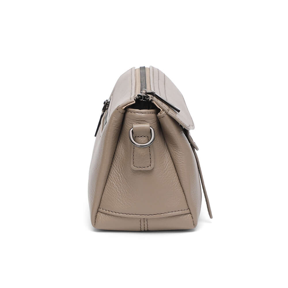 Side angle view of taupe leather small shoulder crossbody purse.