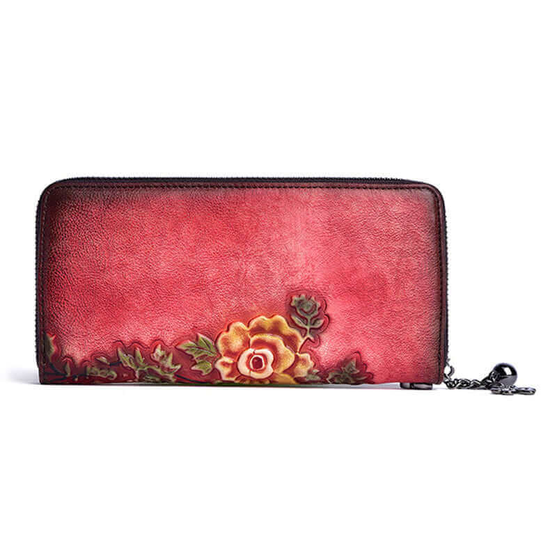 Model holding embossed leather wallet with wristlet