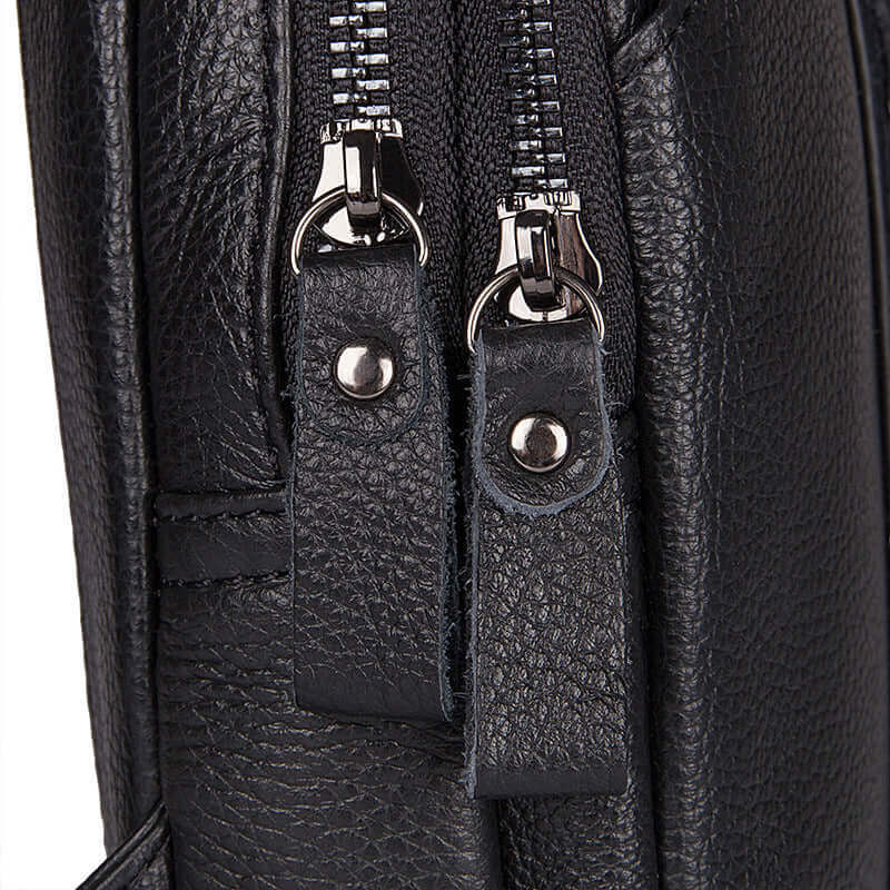 Detailed display of men's leather crossbody bag.