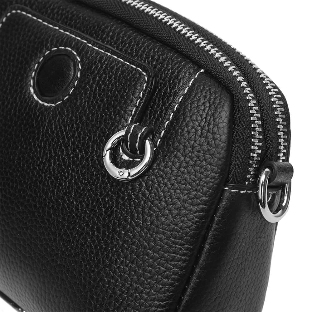 Close-up of mini leather crossbody bag stitching and soft grain texture.