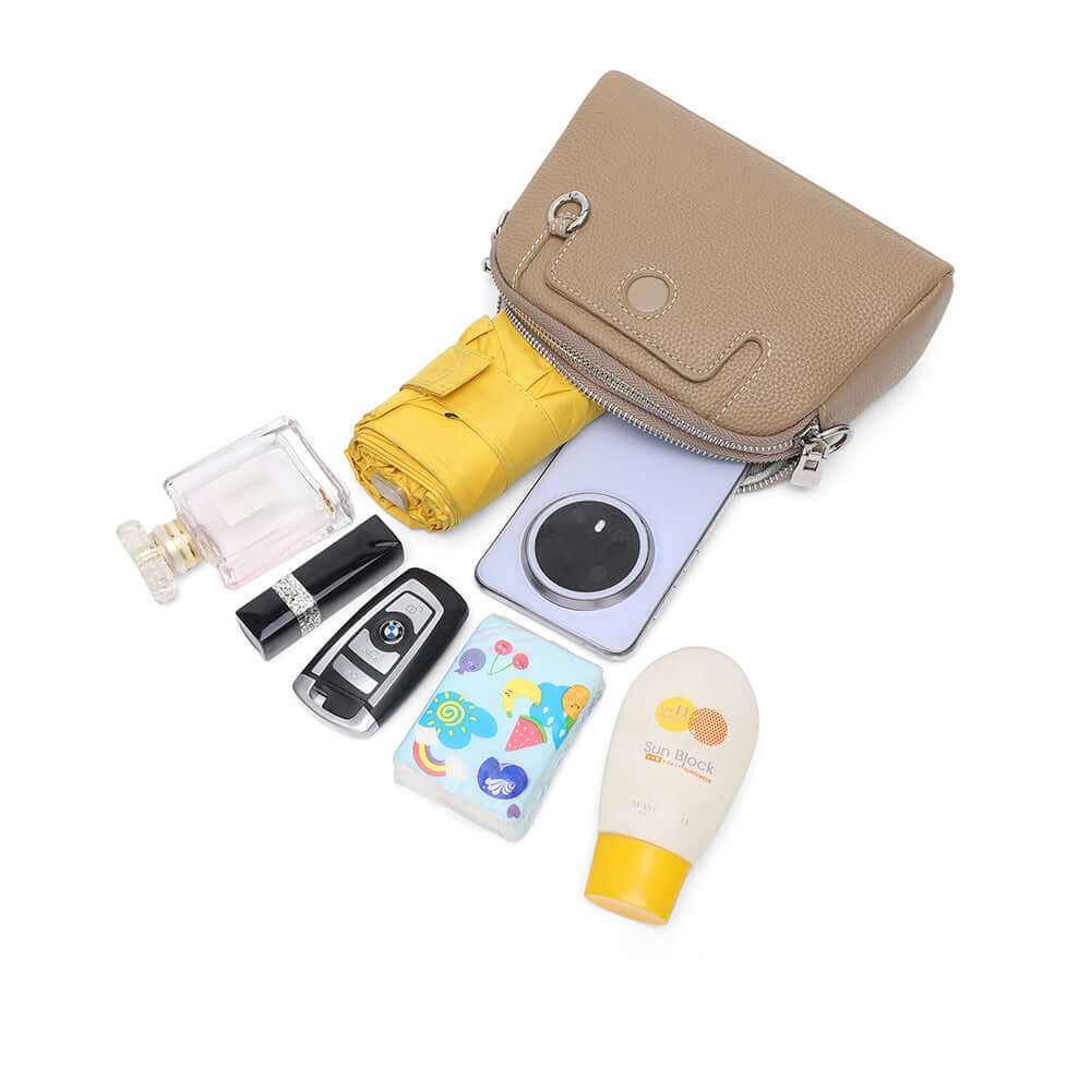 Mini leather crossbody bag laid flat showing compact structured form.