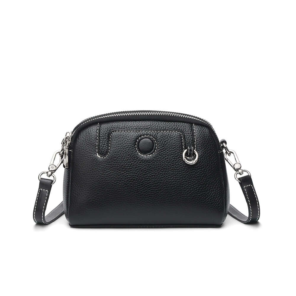 Mini leather crossbody bag front view showing clean shape and smooth grain